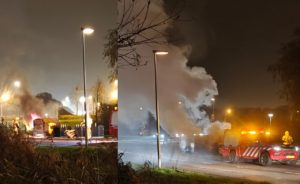 Vlammen slaan uit kledingcontainer aan de Vrijenburgweg